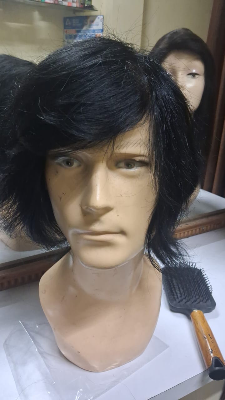 Black wig displayed on a mannequin